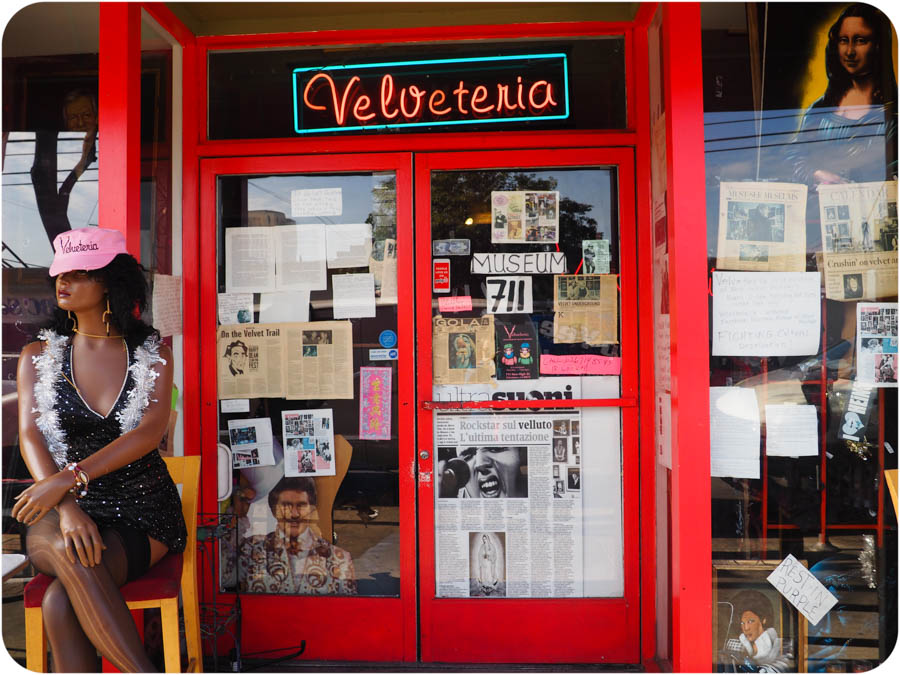 Velveteria storefront with ballerina clown and velvet paintings