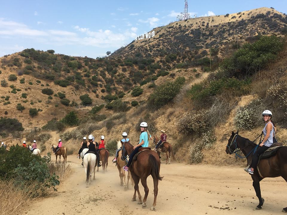Riders on horseback near the Hollywood Sign at Sunset Ranch Hollywood