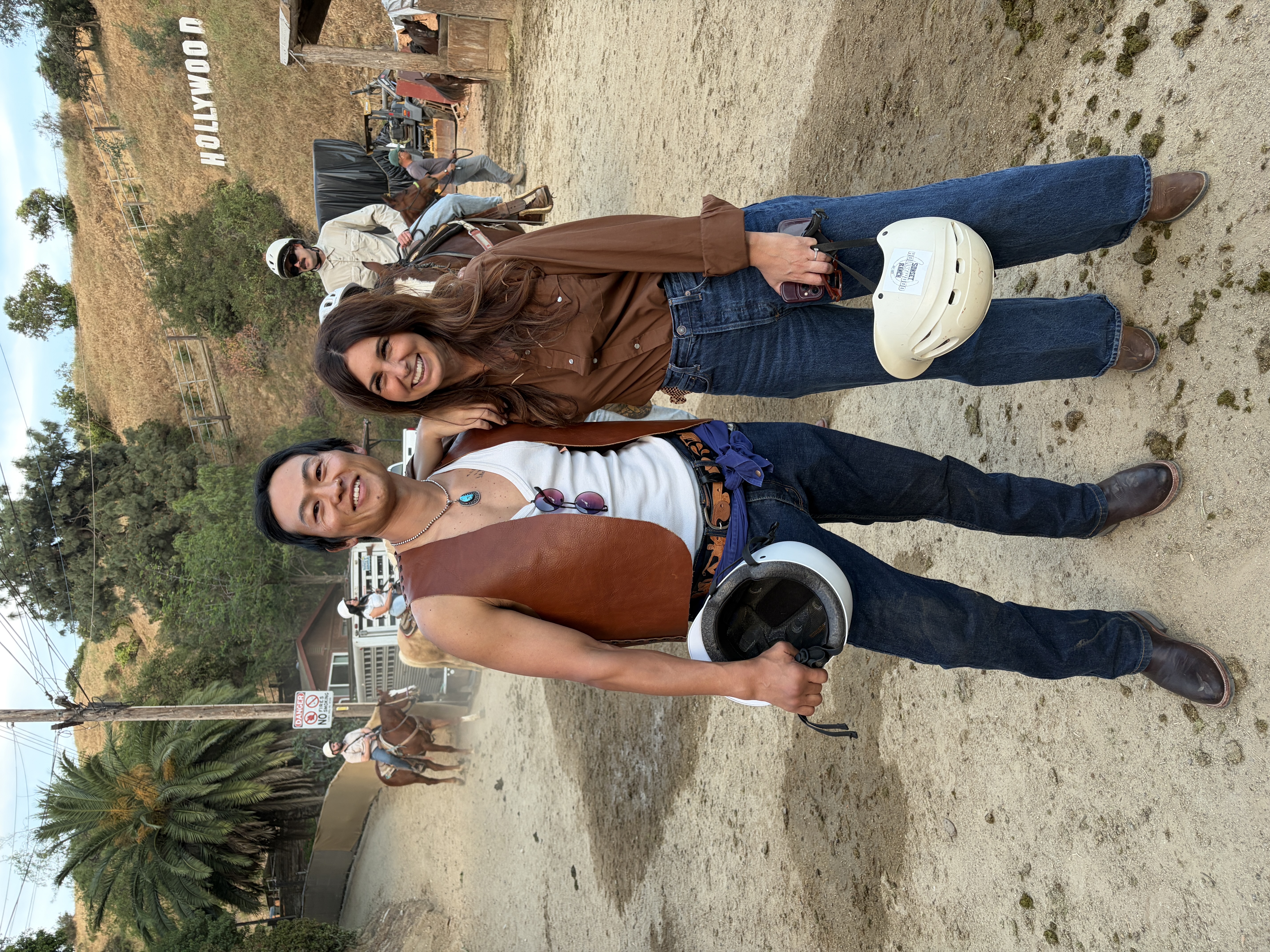 Happy couple after their horseback ride at Sunset Ranch Hollywood, Hollywood Sign visible in the background